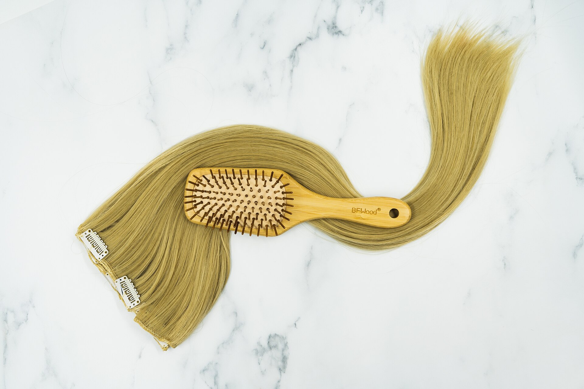 Stylist applying hair extensions